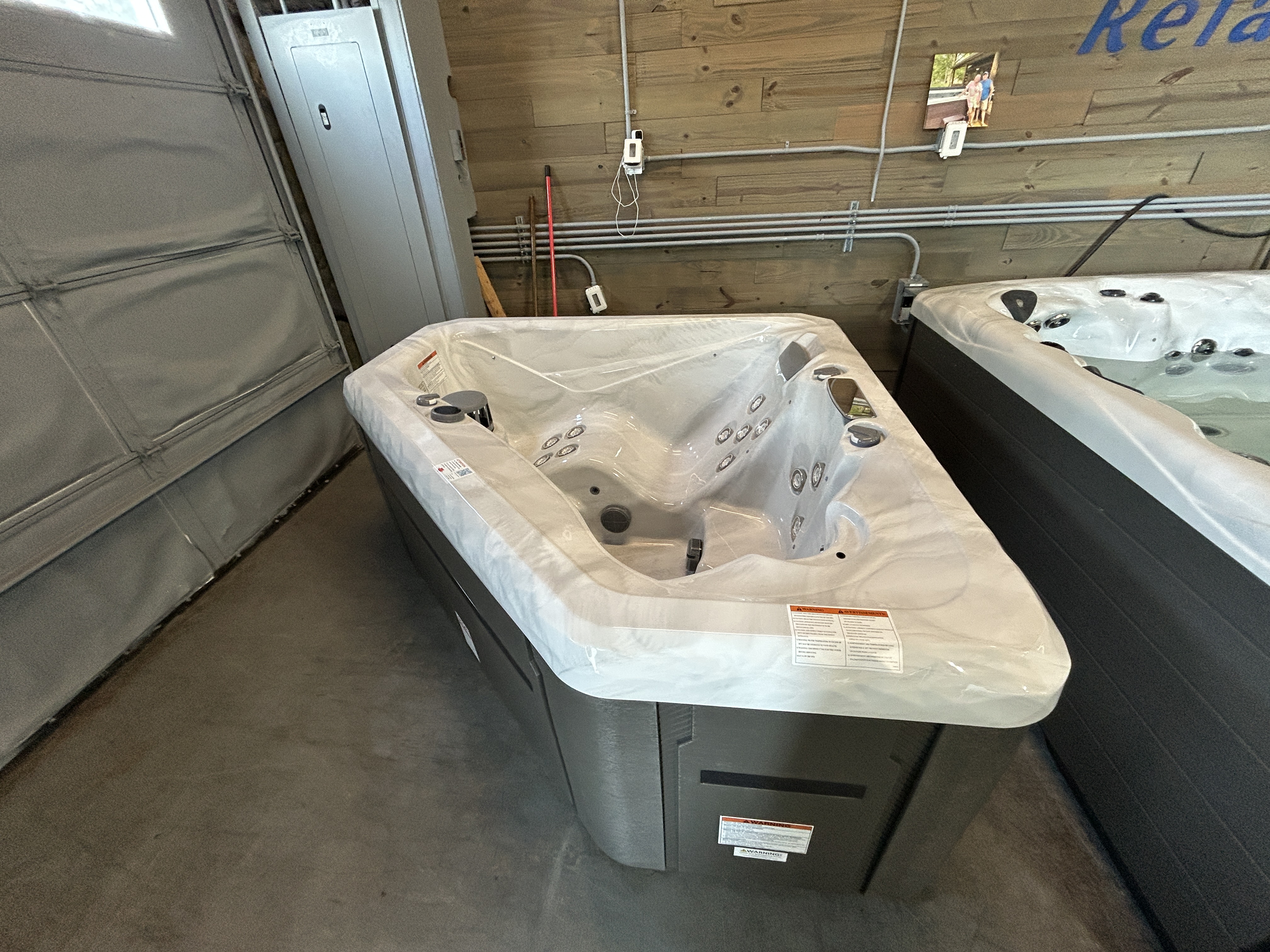 Master Spas TS 240X hot tub on display in a showroom at Healthy Living Spas in Mahomet, IL. It has 2 seats and 26 jets.