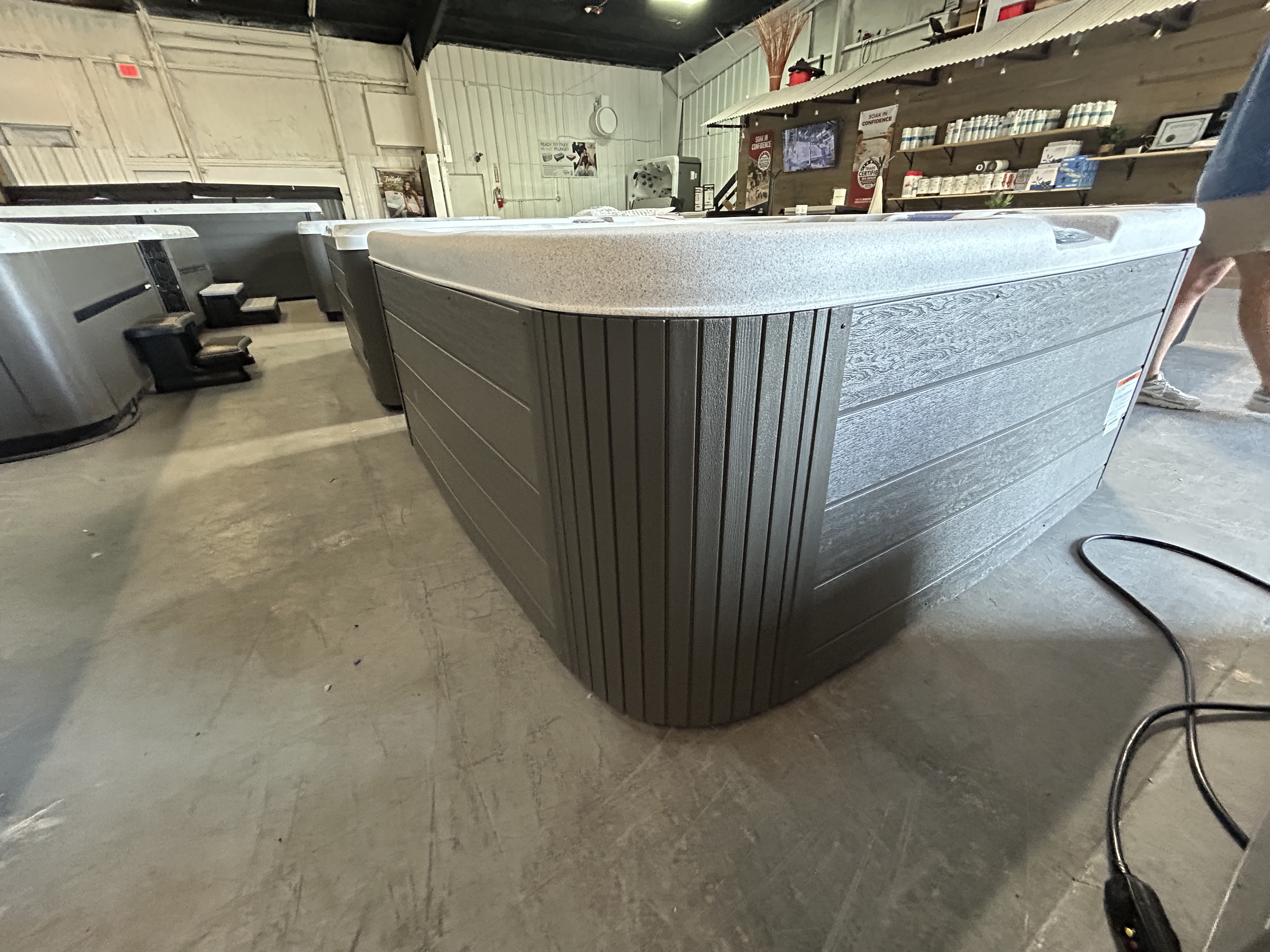 Master Spas Bar Harbor LE on the showroom floor - graphite skirting
