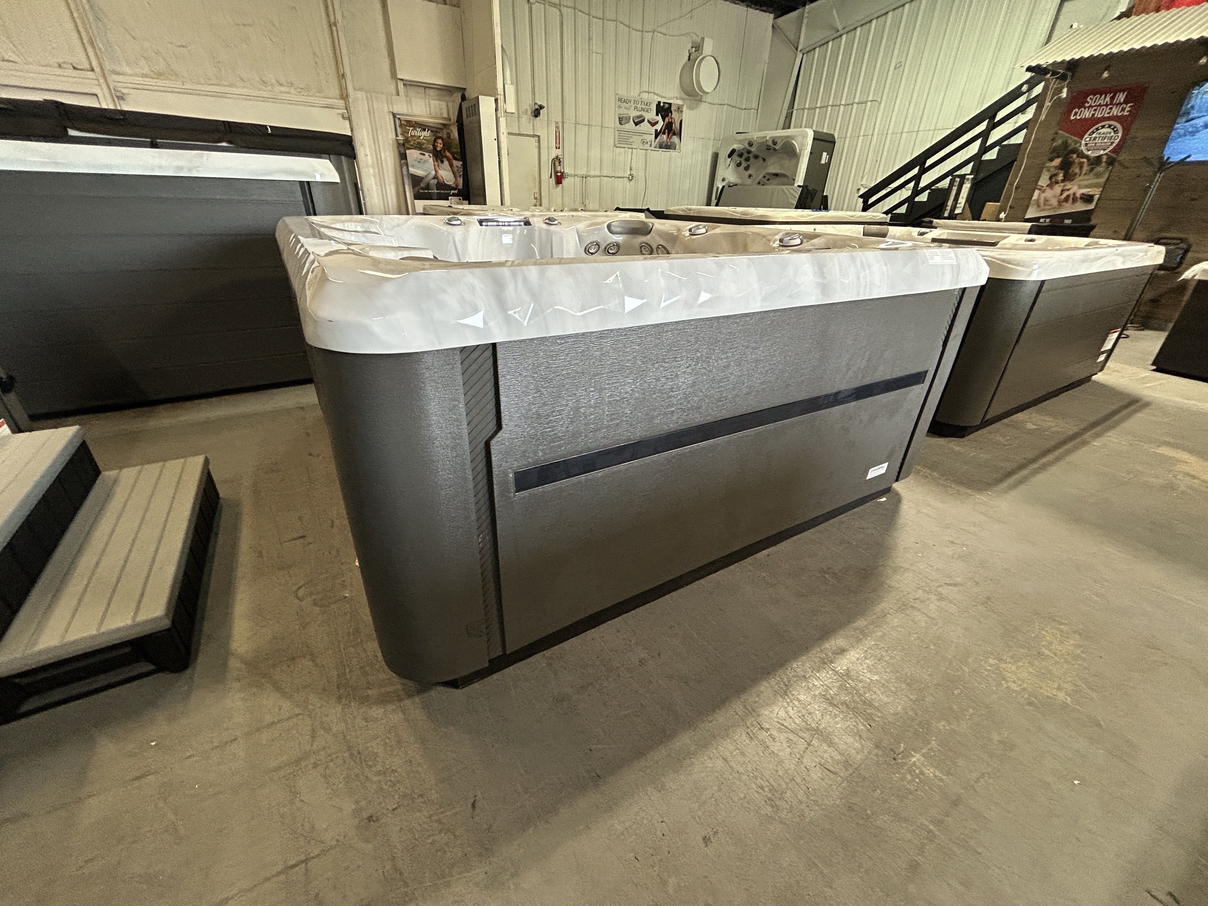 Master Spas TS 7.25 hot tub with 6 seats and 37 jets, measuring 84x84x38 inches, on a dealer showroom floor in Mahomet, IL.