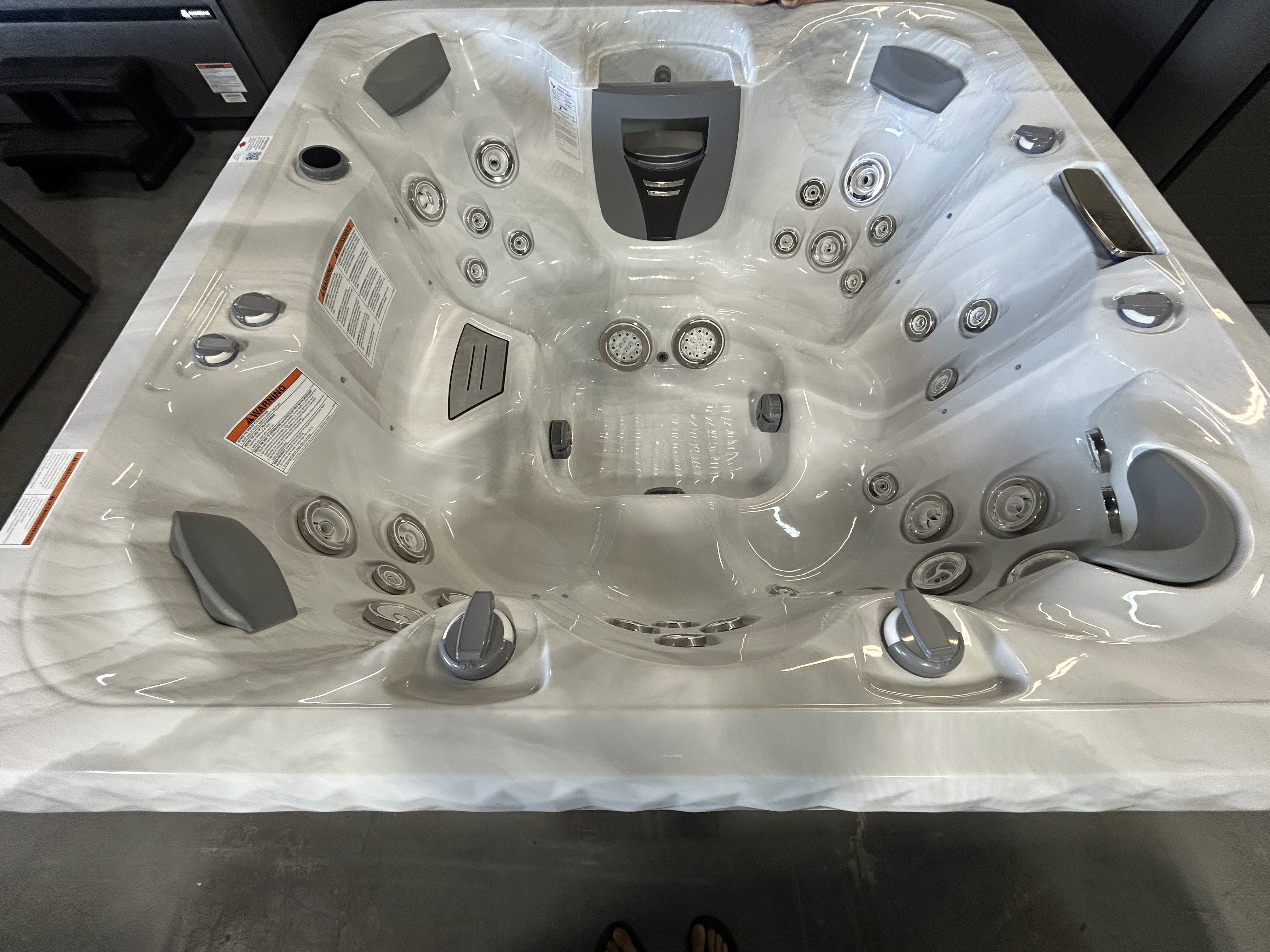 Master Spas TS 7.25 hot tub, 84x84x38 inches, on a dealer showroom floor in Mahomet, IL.